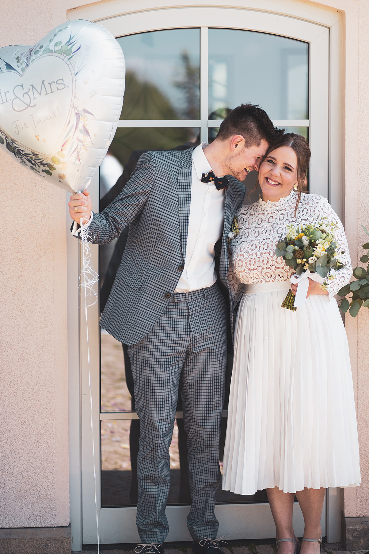Hochzeitspaar mit herzförmigem Luftballon
